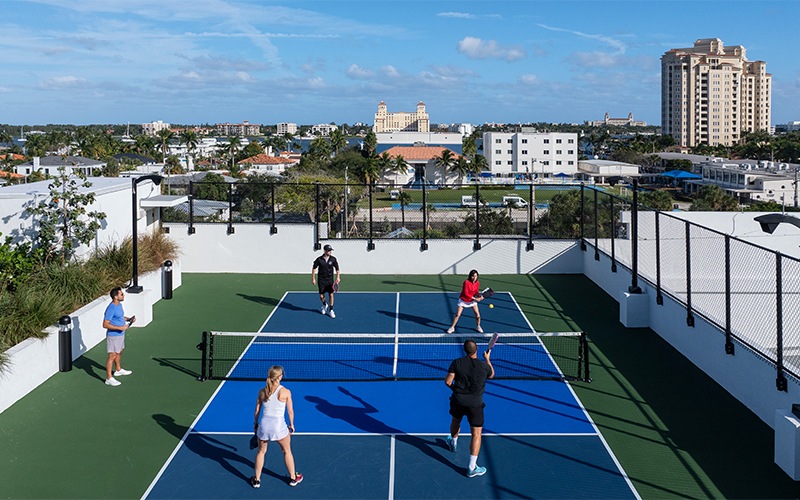 a group of people playing pickleball