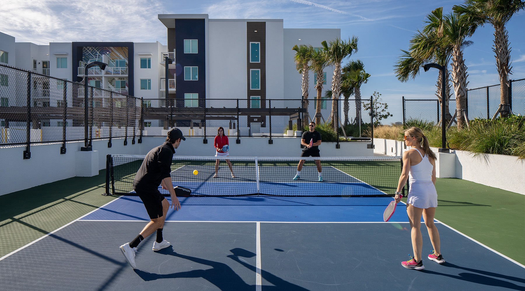 a group of people playing pickleball