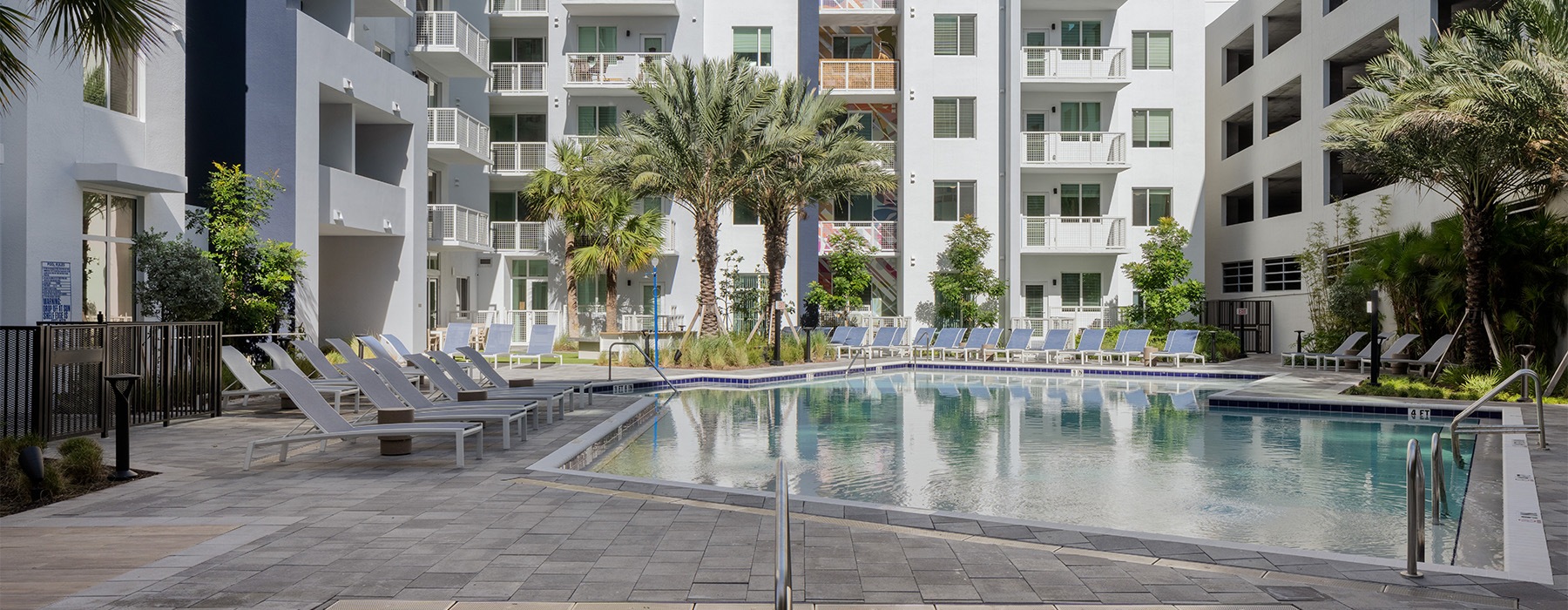 a pool surrounded by trees and chairs